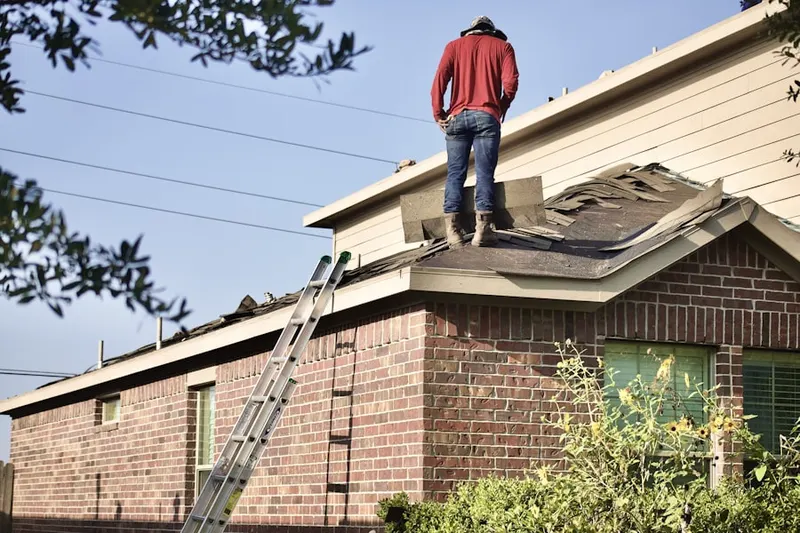 Professional roofer working on a residential roof in Whitefish